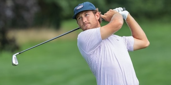 Christian Cavaliere watching an iron shot in mid-follow-through